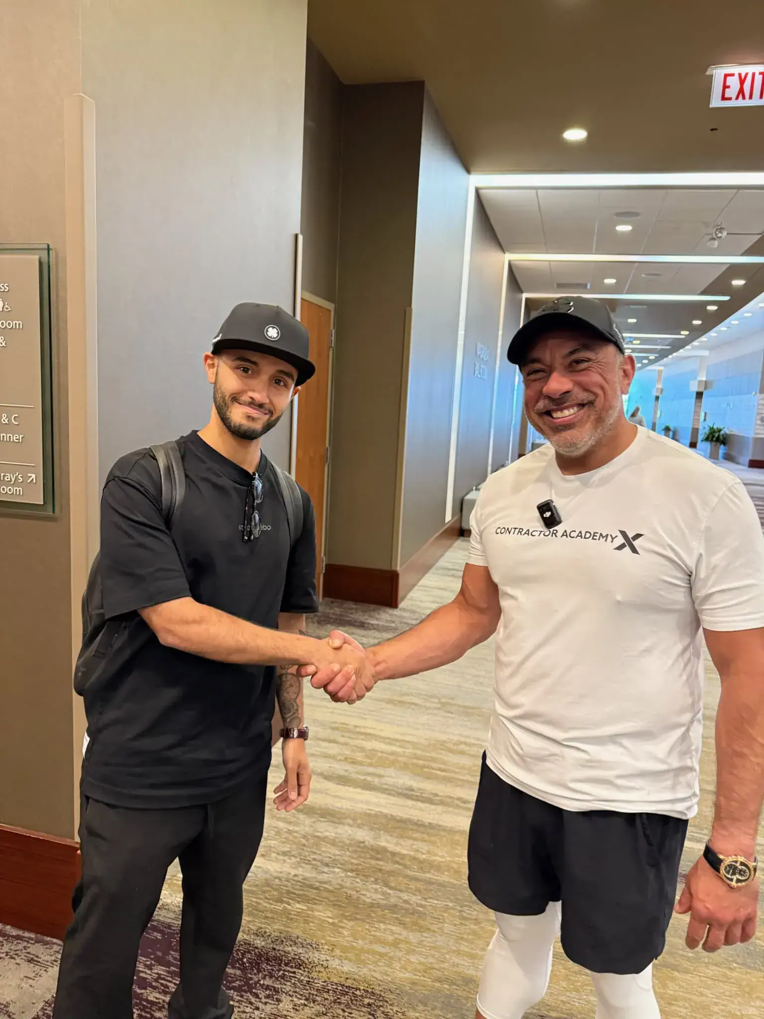 Mike Flores shaking hands with a Roofing Academy X student